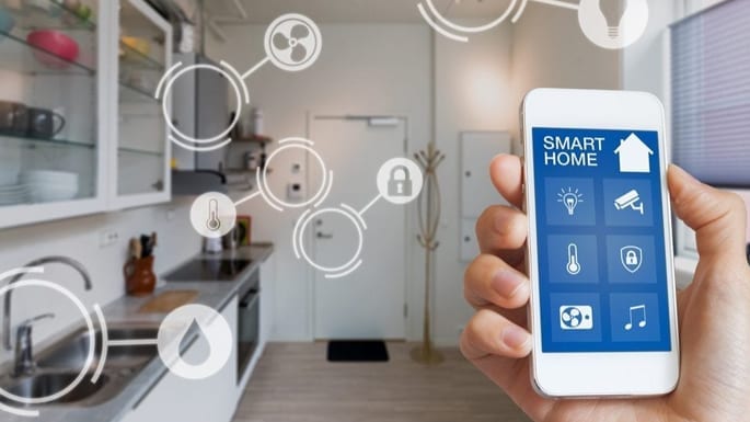 A cell phone controls numeroues smart devices in a kitchen.