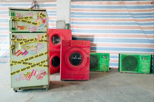 Broken home appliances in a garage.