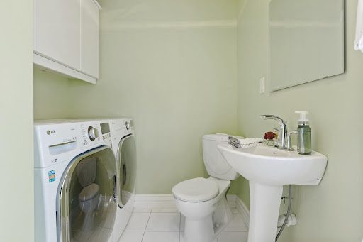A washer and dryer installed in a bathroom.